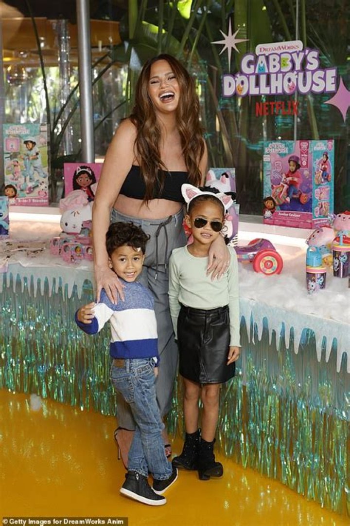 Chrissy Teigen Rocks A Crop Top While Pregnant & Holds Hands With Adorable Kids At Grocery Store