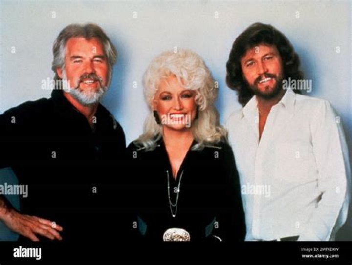Dolly Parton Mourns Friend Kenny Rogers: ‘He’ll Be Asking God To Spread Some Light On This Darkness’