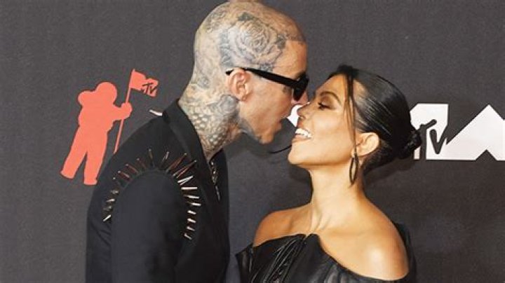 Kourtney Kardashian Sweetly Hugs Travis Barker In New BTS Photos Of MGK’s Tour