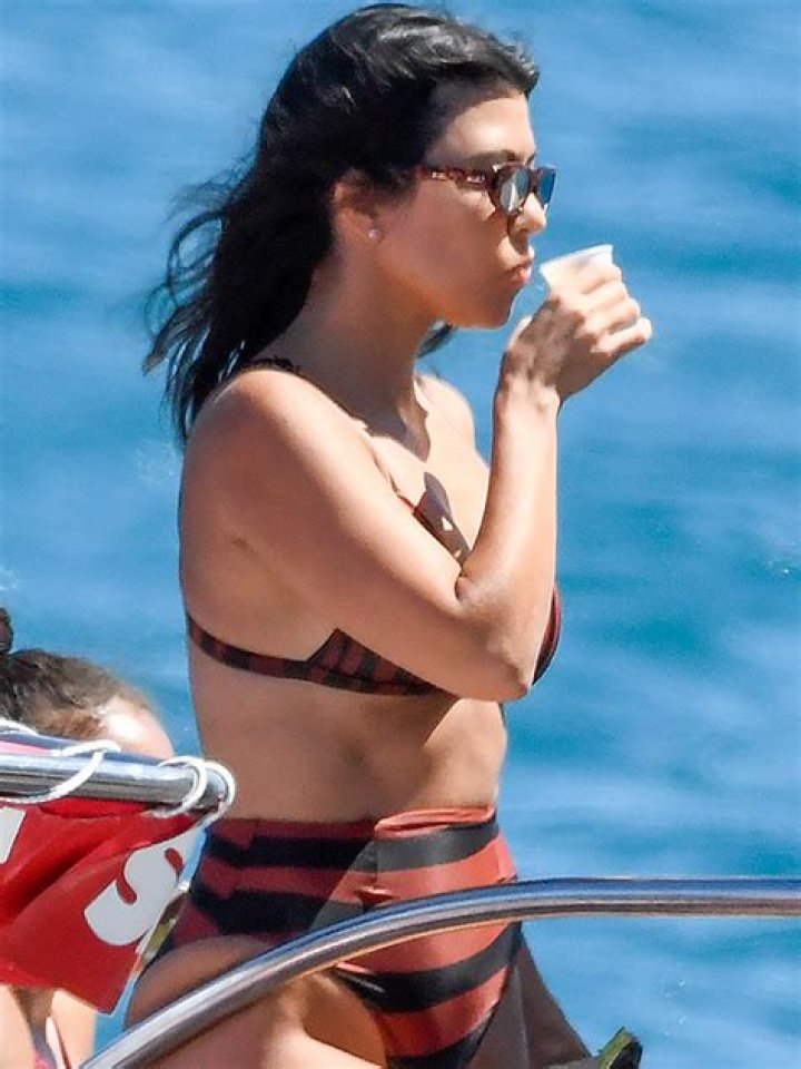 Kourtney Kardashian Rocks A Purple Bikini While Lounging By The Pool — Photo