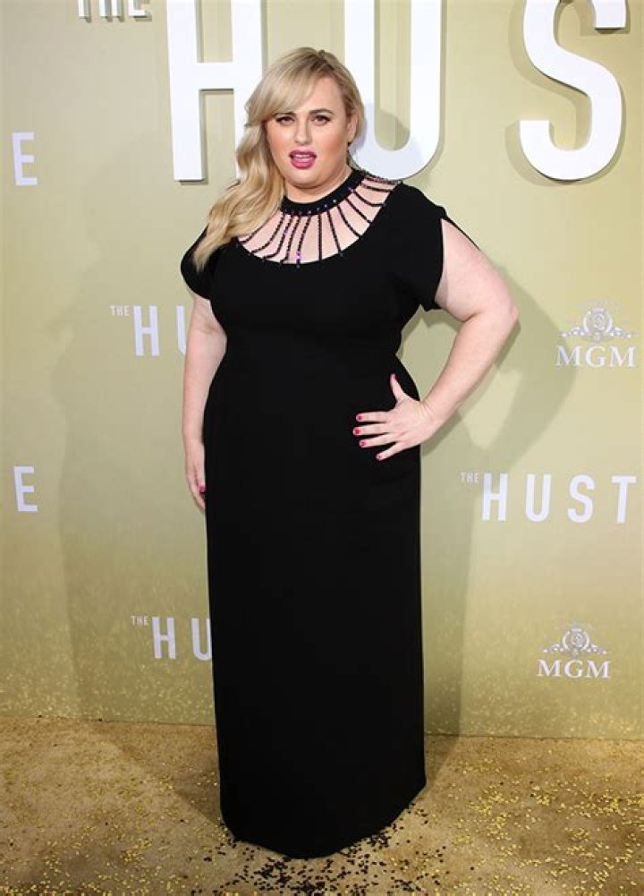 Rebel Wilson Looks Gorgeous In A Black Zip-Down Swimsuit In Palm Beach After Losing 60 Lbs. — See Pic